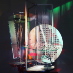 A metal sculpture in the Bauhaus style with a circular metal disc punched with holes and vertical strips of metal