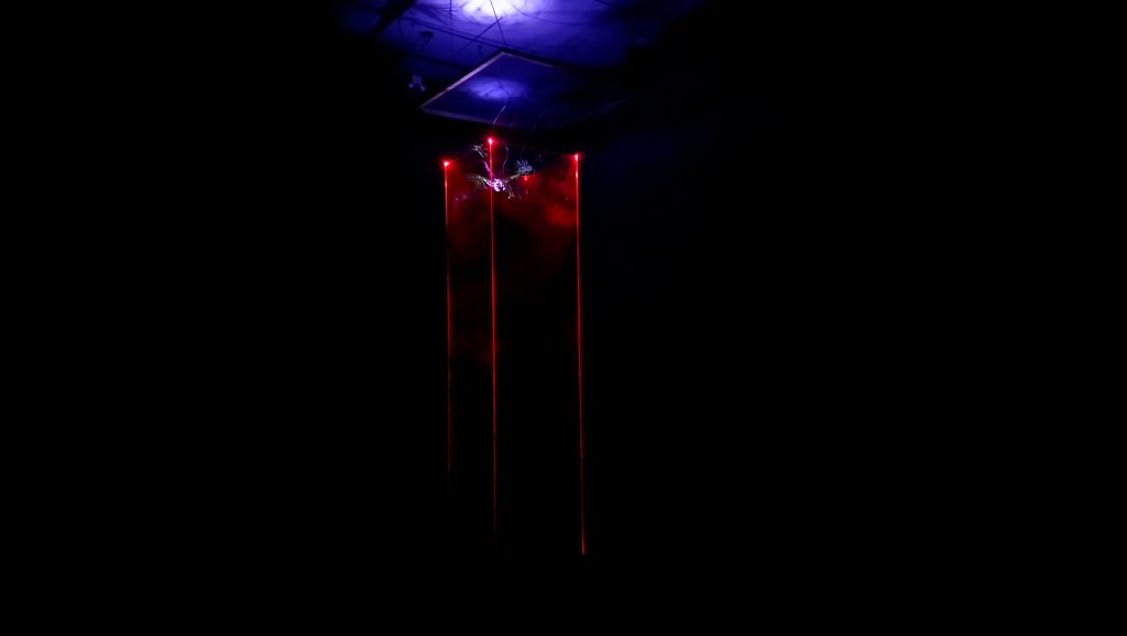 A perspex column in the dark, with a light above it and soil inside